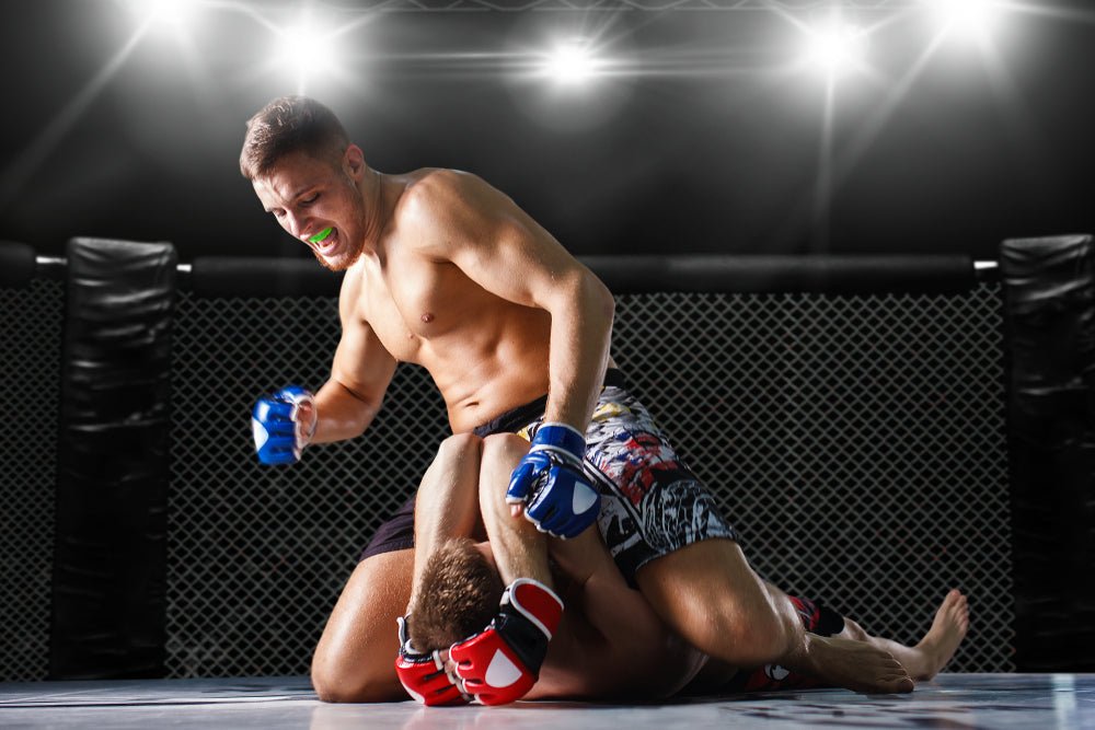 MMA fighter punching opponent on the ground