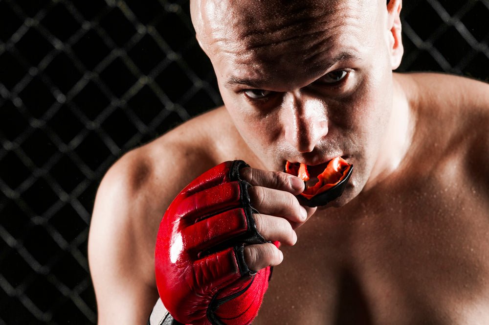 Fighter putting in a mouthguard